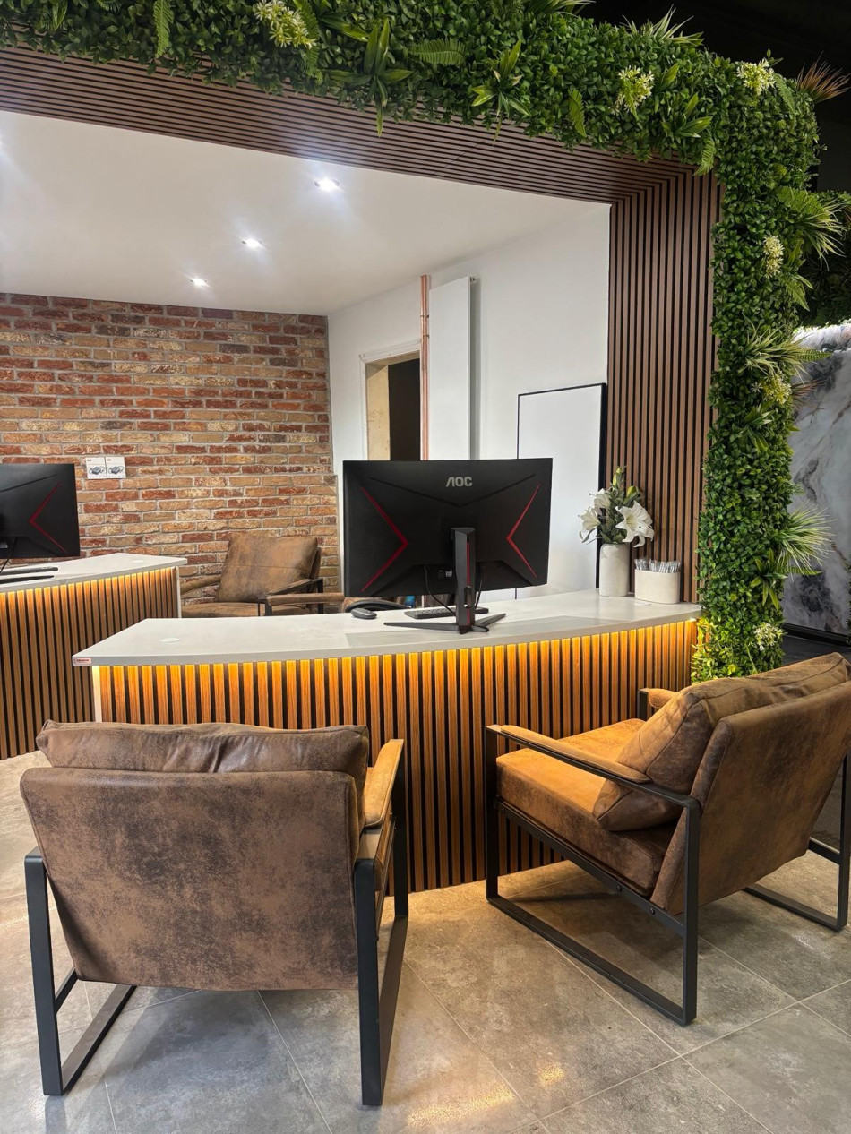 Contemporary office interior with a vibrant green wall and elegant wooden furniture, promoting a natural atmosphere.