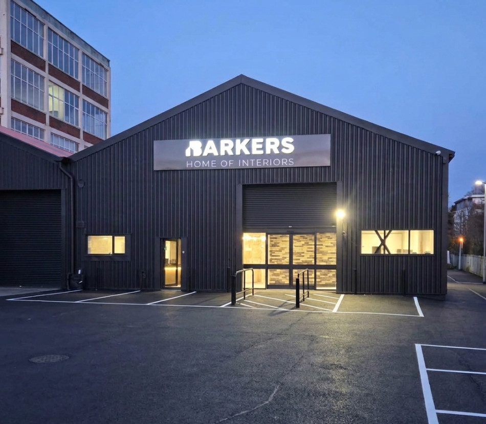 The brightly lit entrance of a bathroom showroom at night, showcasing its welcoming atmosphere.
